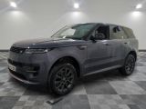 a grey land rover parked in a garage with a checkered floor