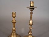 pair of antique brass candlesticks on a grey background