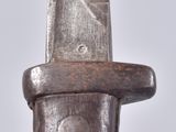 a close up of a knife on a white surface