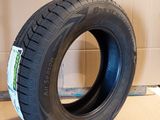 tire on the floor in front of a cardboard box with a cardboard box in the background