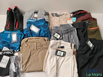 several pairs of men ' s pants are laid out on a table