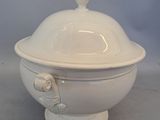 a large white bowl with a lid on a table