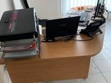 a desk with two laptops and a printer on top of it