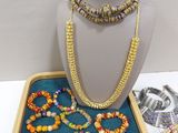 a display case with a necklace and bracelets on it