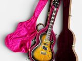 an image of a guitar and a case on a white surface