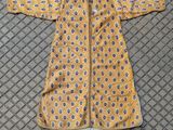a yellow jacket with a blue and white pattern on it