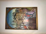 a picture of a painting on the wall above a bed