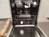 a dishwasher in the middle of a kitchen with a tray in it
