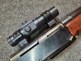 two rifles are laying next to each other on the ground