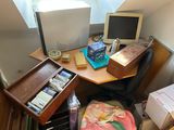 a desk with a computer monitor and other items on it