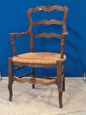 une chaise en bois avec une assise marron et un mur bleu en arrière-plan