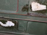 a piece of paper sticking out of an old green stove