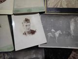 many old photos of a woman and a horse on a table