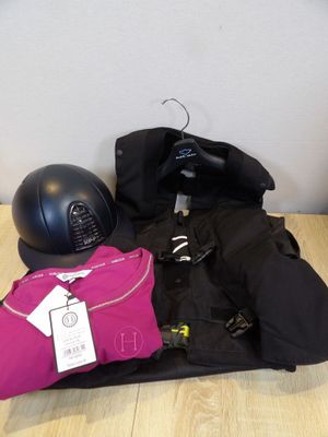 a pile of clothing and a helmet on the floor