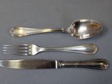 three spoons and a fork on a table