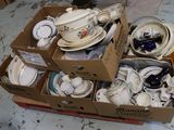 une boîte remplie d'assiettes et de bols posée par terre