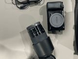 a camera and other electronics laid out on a table