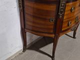 a marble top dresser in a room with a painting on the wall