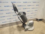 the floor polisher is sitting on the floor in front of a wall