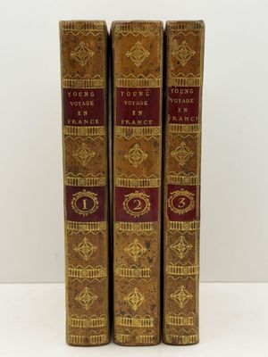 three books are sitting on top of each other on a table