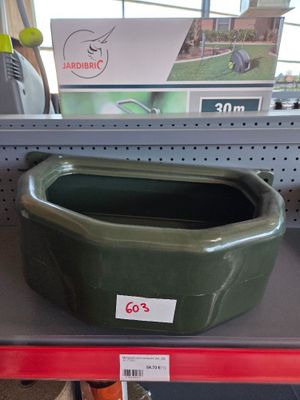 a green bowl on a shelf in a store