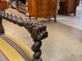a chair that has a lion head on the back of it