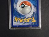 a pokemon card in a plastic holder on a table