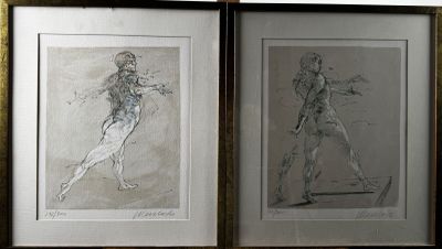 two framed drawings of a man and a woman on the wall