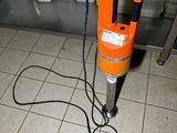 an orange machine that is sitting on a tiled floor