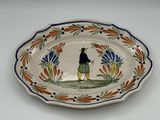 a plate with a picture of a man holding a golf club