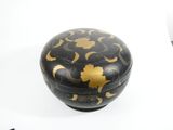 a black and gold box with gold designs on it