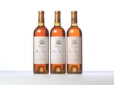 three bottles of wine sitting on top of a white table