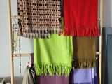 a ladder that has a bunch of different colored blankets hanging on it