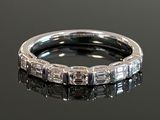 a close up of a diamond ring on a black surface