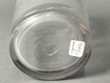 a glass jar with a label on it sitting on a table