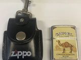 a lighter and a lighter case sitting next to each other