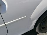a white car that is parked on the side of the road