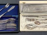 silverware in a box on a table with a blue cloth