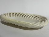 a white plate with a spiral design on it