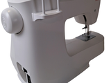 a white sewing machine that is sitting on a table
