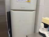 a refrigerator and a blender in a small kitchen