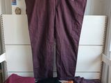 purple pants hanging on a clothes rack in front of a window