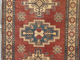a red and blue rug with a geometric design on it