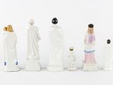 several figurines of people and a dog are lined up in a row