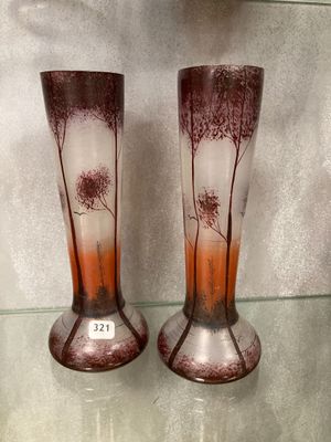 two vases that are sitting on a glass shelf