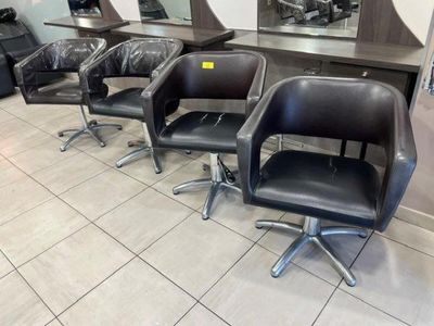 four chairs that are sitting in front of a mirror