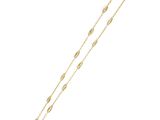 a gold plated bracelet with a long chain and a leaf design