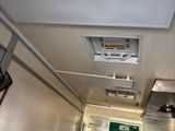 an image of a hallway with a door and a ceiling fan