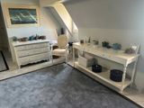 an image of a bedroom with a bed and a dresser