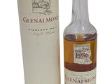 a bottle of glenalmon whisky next to a cardboard box